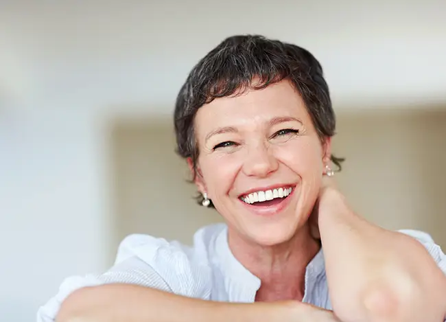 happy middle aged woman telehealth therapy california